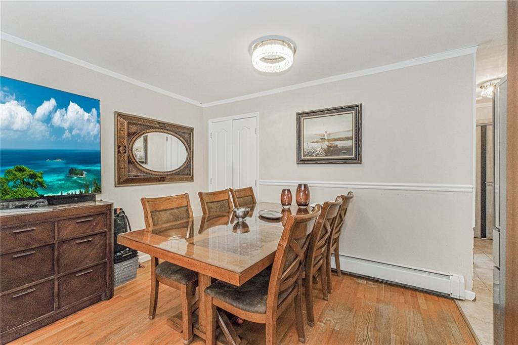 2809 East 28th Street, Unit 1C Brooklyn, NY 11235 - Photo 7 of 38 a view of a dining room with furniture and wooden floor