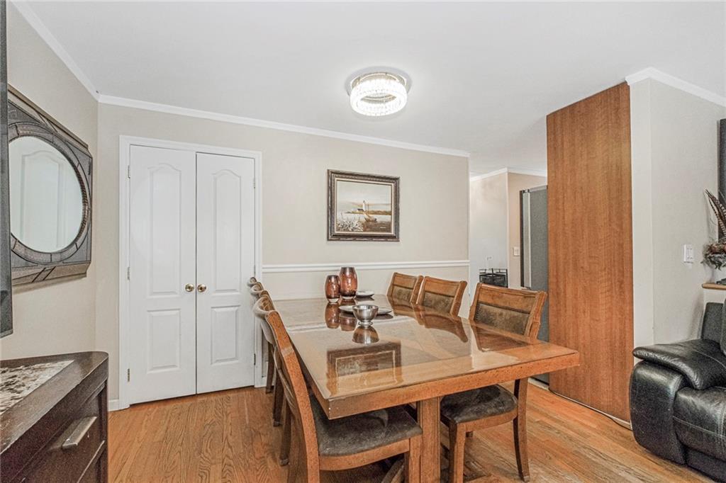 2809 East 28th Street, Unit 1C Brooklyn, NY 11235 - Photo 10 of 38 a view of a dining room with furniture and wooden floor