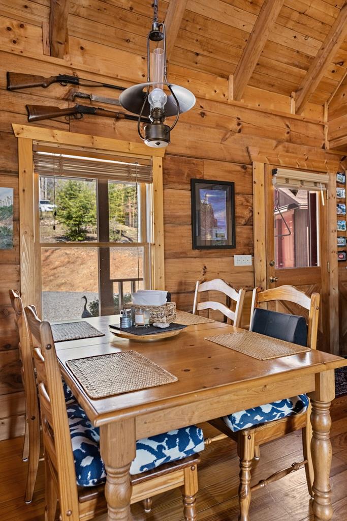 114 Hunter Hill Way Ellijay, GA 30540 - Photo 13 of 41 a view of a dining room with furniture a chandelier and wooden floor