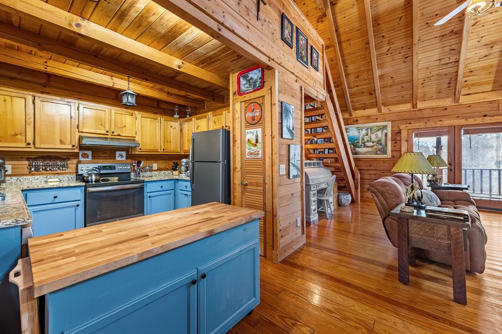 114 Hunter Hill Way Ellijay, GA 30540 - Photo 17 of 41 a kitchen with stainless steel appliances kitchen island granite countertop a table chairs and wooden floors