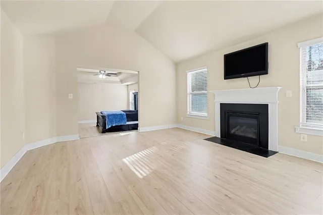 a living room with a fireplace and a flat screen tv