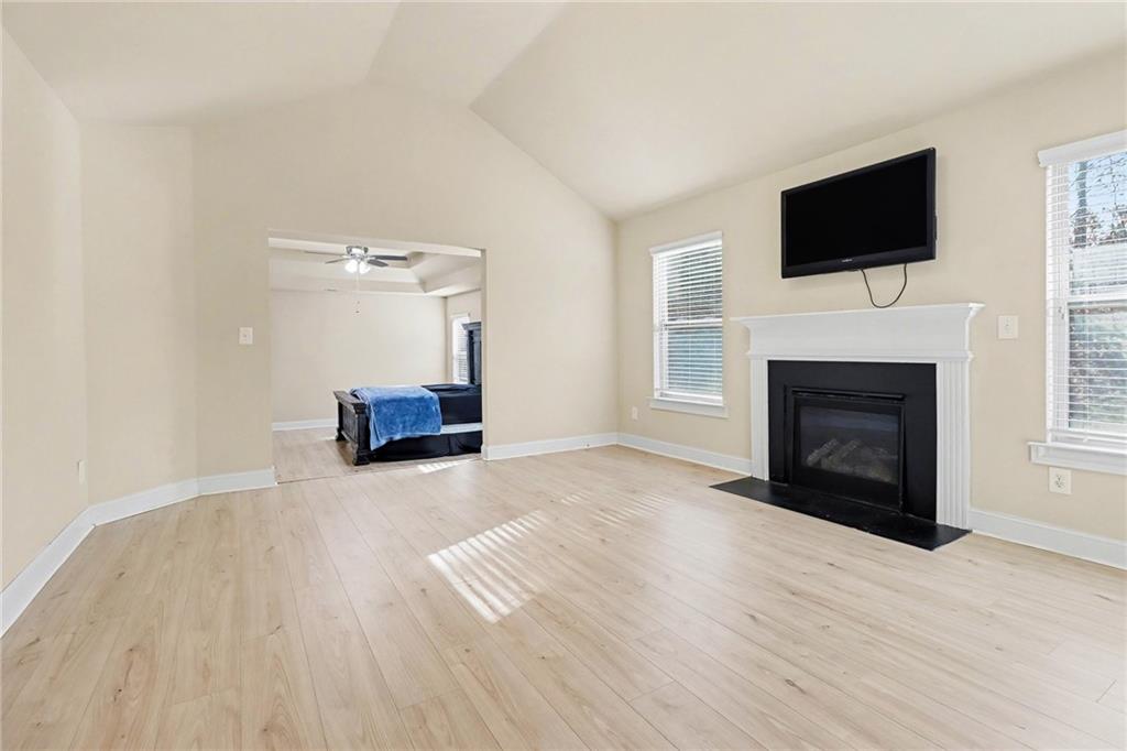 6791 Potomac Place Fairburn, GA 30213 - Photo 11 of 23 a living room with a fireplace and a flat screen tv