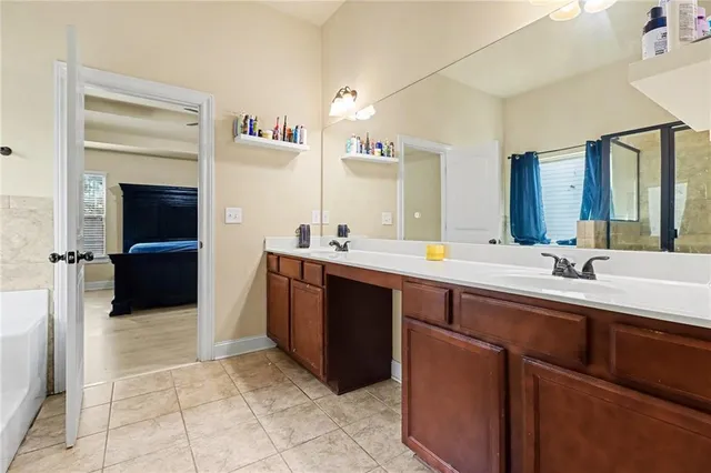 a bathroom with a sink double vanity and a mirror