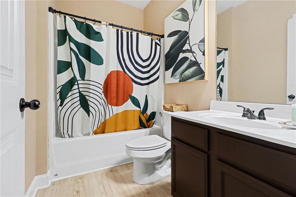 6791 Potomac Place Fairburn, GA 30213 - Photo 18 of 23 a bathroom with a sink a toilet and a mirror