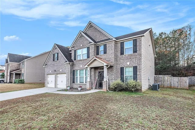 a front view of a house with a yard
