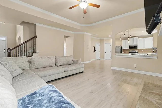 a living room with furniture and kitchen view