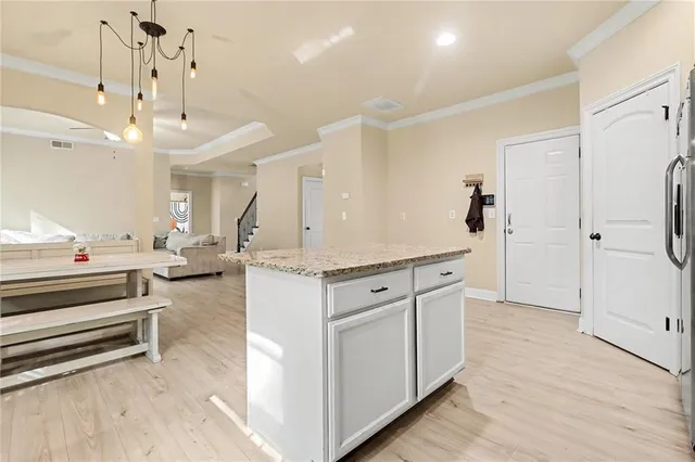 a spacious bathroom with a granite countertop sink mirror and vanity