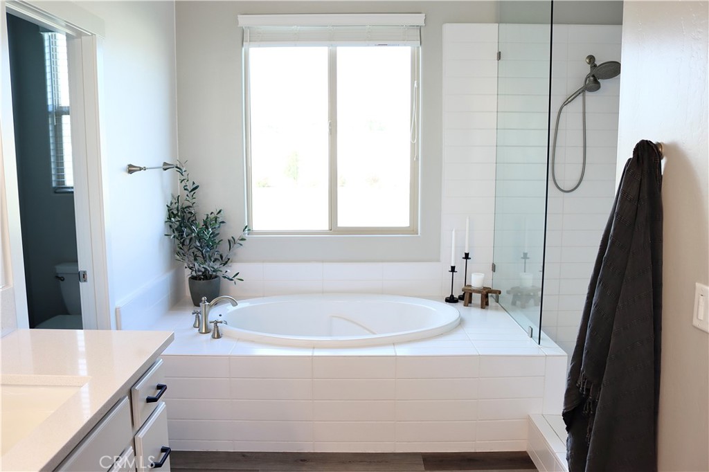2018 Risborough Court Bakersfield, CA 93311 - Photo 34 of 73 a bathroom with a tub sink and mirror
