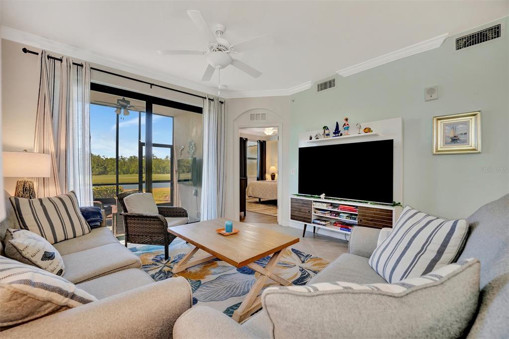 17724 Gawthrop Drive, Unit 101 Bradenton, FL 34211 - Photo 11 of 28 a living room with furniture and a flat screen tv