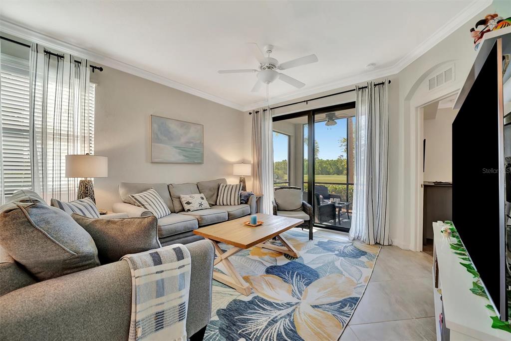 17724 Gawthrop Drive, Unit 101 Bradenton, FL 34211 - Photo 12 of 28 a living room with furniture and a large window