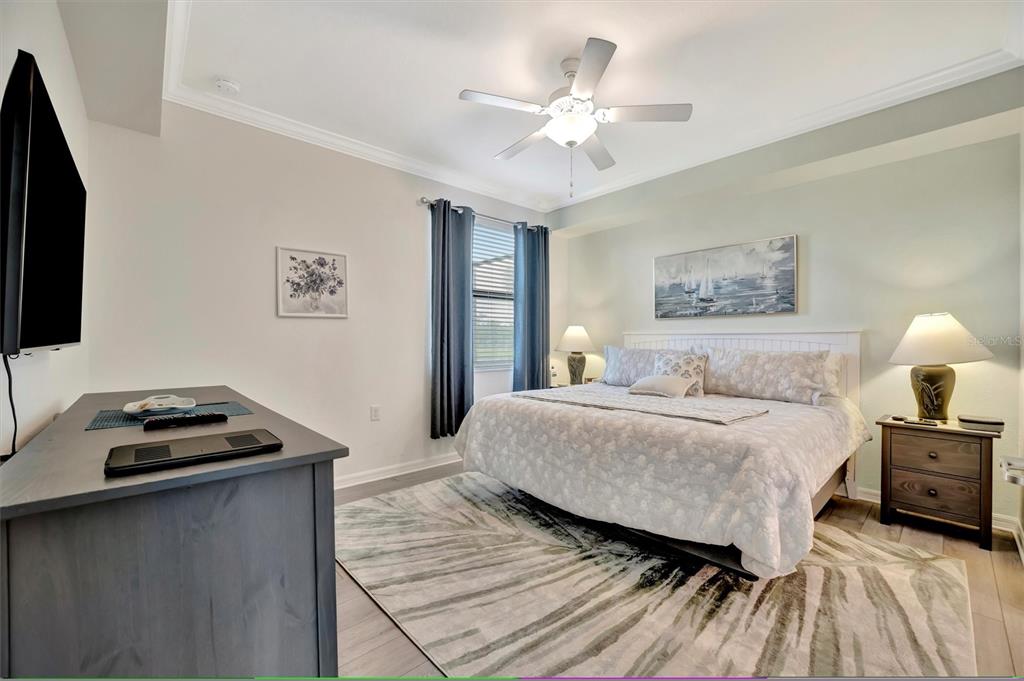 17724 Gawthrop Drive, Unit 101 Bradenton, FL 34211 - Photo 15 of 28 a bedroom with a bed and a flat screen tv