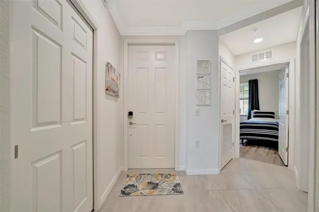 a bedroom with two beds and a chandelier