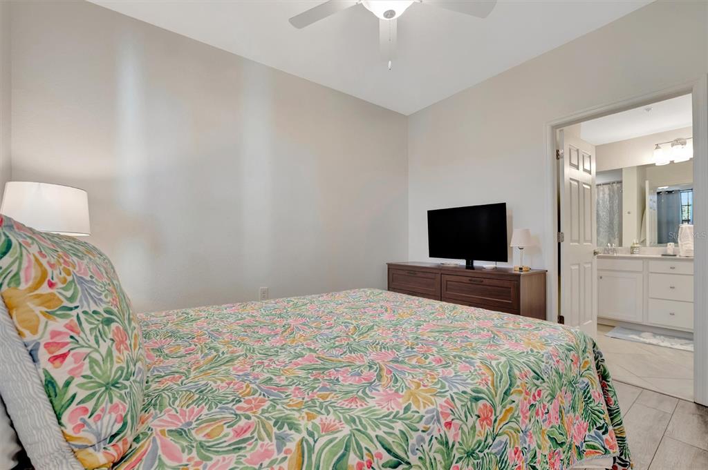 17724 Gawthrop Drive, Unit 101 Bradenton, FL 34211 - Photo 19 of 28 a bedroom with a bed and a television