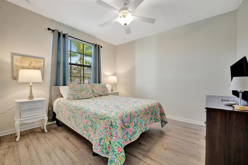 17724 Gawthrop Drive, Unit 101 Bradenton, FL 34211 - Photo 20 of 28 a bedroom with a bed lamp on desk and a window