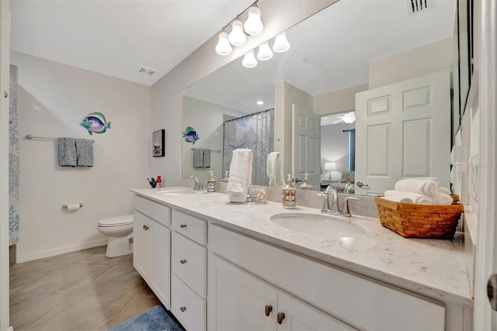 17724 Gawthrop Drive, Unit 101 Bradenton, FL 34211 - Photo 21 of 28 a spacious bathroom with a double vanity sink mirror and toilet