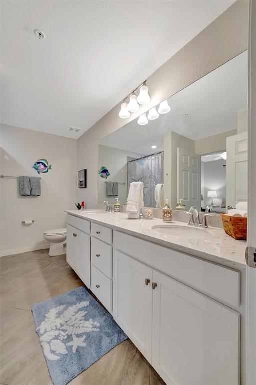 17724 Gawthrop Drive, Unit 101 Bradenton, FL 34211 - Photo 22 of 28 a spacious bathroom with double sink and a mirror