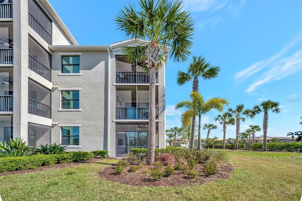 17724 Gawthrop Drive, Unit 101 Bradenton, FL 34211 - Photo 26 of 28 a front view of multi story residential apartment building with yard and green space