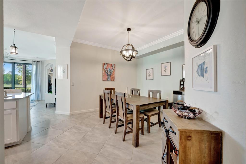 17724 Gawthrop Drive, Unit 101 Bradenton, FL 34211 - Photo 5 of 28 a view of a dining room with furniture and a chandelier