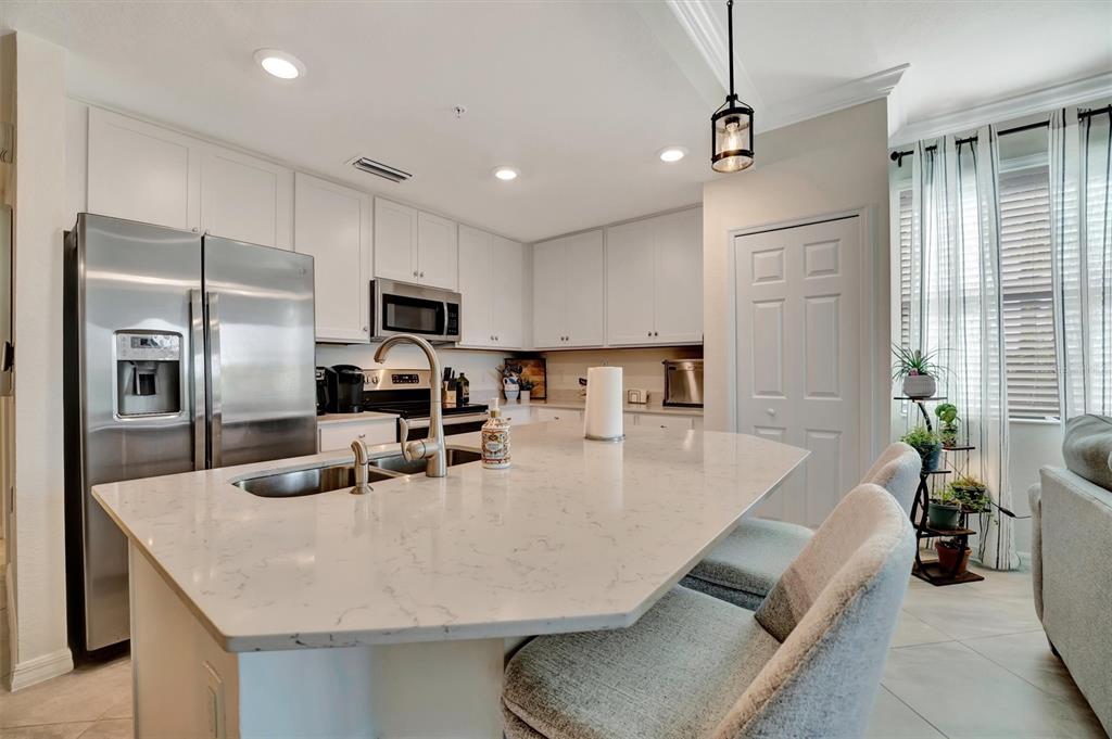 17724 Gawthrop Drive, Unit 101 Bradenton, FL 34211 - Photo 9 of 28 a kitchen with stainless steel appliances granite countertop a sink a stove and a refrigerator