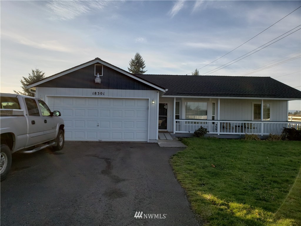 18301 Brandywine Court Southwest Rochester, WA 98579 - Photo 1 of 25 a front view of a house with a garden