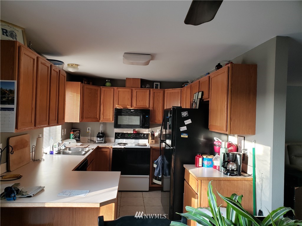 18301 Brandywine Court Southwest Rochester, WA 98579 - Photo 14 of 25 a kitchen with a sink stove and refrigerator