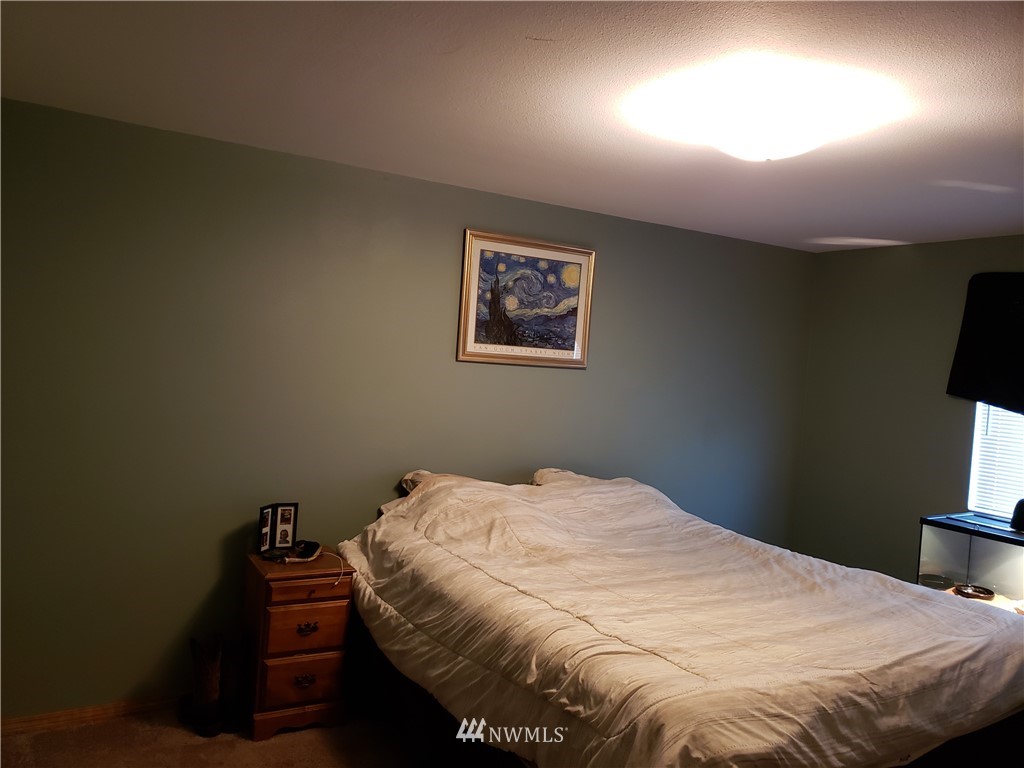 18301 Brandywine Court Southwest Rochester, WA 98579 - Photo 18 of 25 a bedroom with a bed and a television