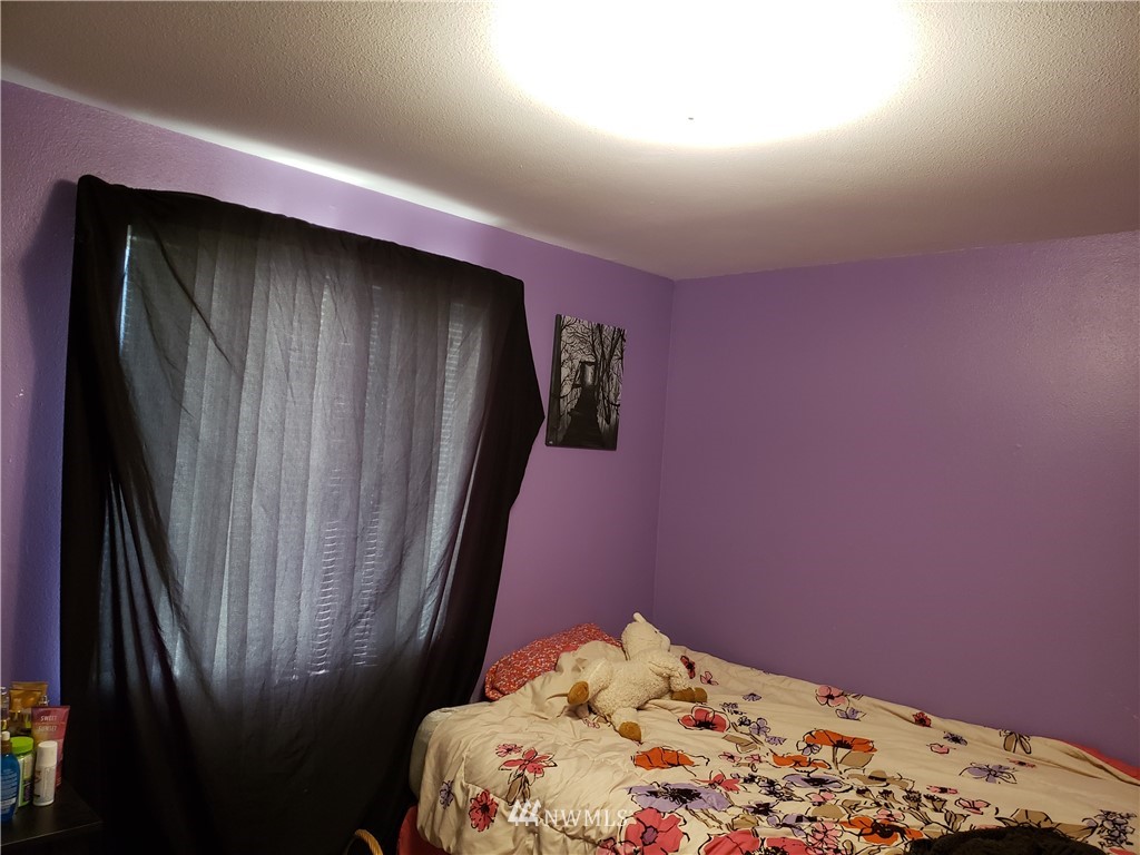18301 Brandywine Court Southwest Rochester, WA 98579 - Photo 23 of 25 a bedroom with a bed and a window