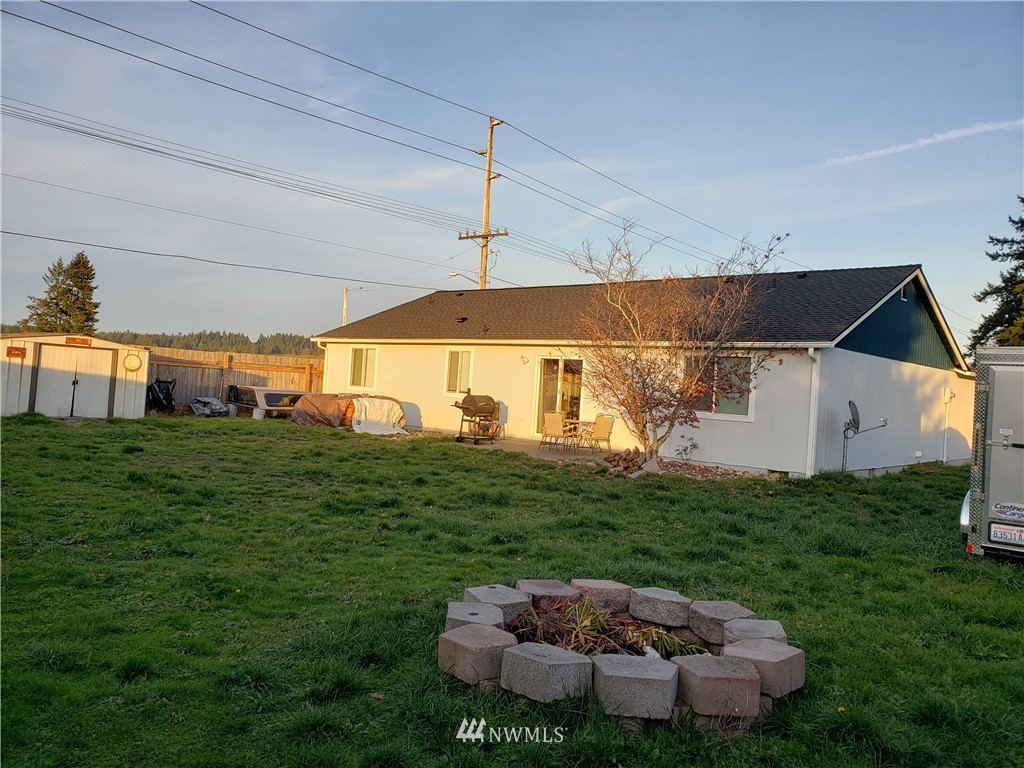 18301 Brandywine Court Southwest Rochester, WA 98579 - Photo 7 of 25 a backyard of a house with table and chairs