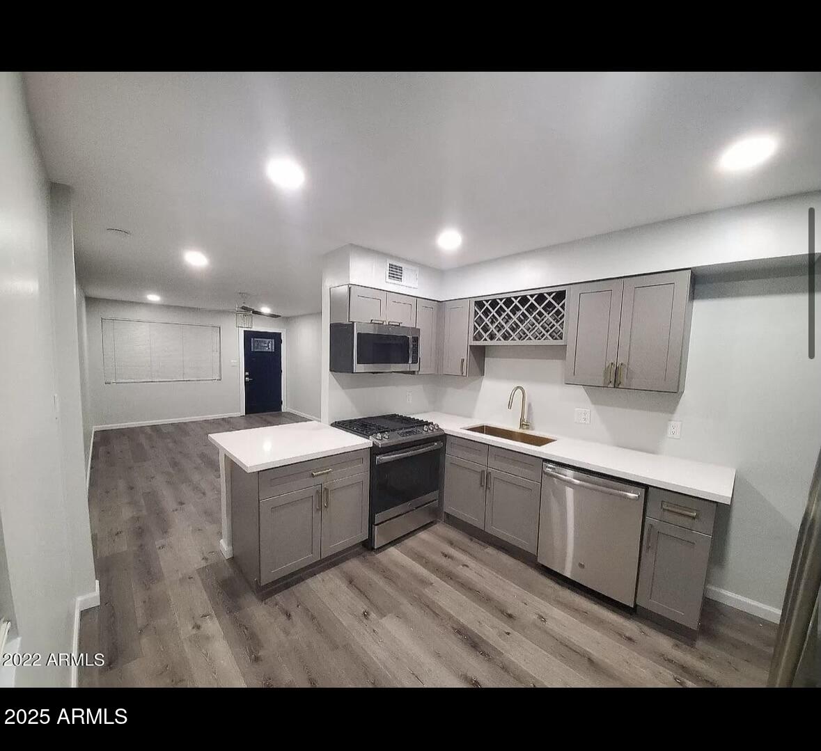 6233 North 14th Street, Unit A Phoenix, AZ 85014 - Photo 2 of 5 a large white kitchen with stainless steel appliances