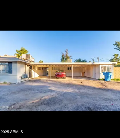 a view of a big yard with an outdoor seating