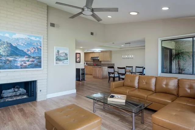 a view of an chairs and table in front of house