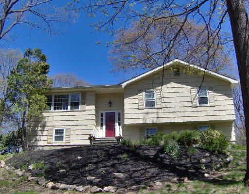 105 Round Lake Road Ridgefield, CT 06877 - Photo 1 of 1 a house with trees in the background