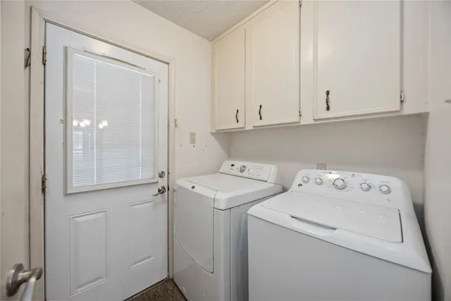 an empty room with a ceiling fan and a window