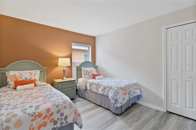 a bedroom with two beds and a window