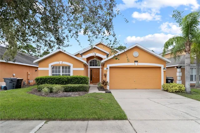 a front view of a house with a yard and garage