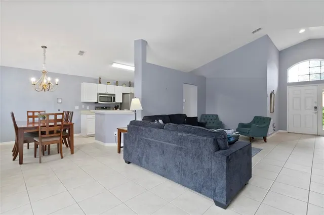 a living room with furniture and kitchen view
