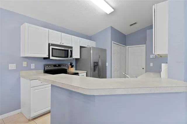 a kitchen with a refrigerator stove and microwave
