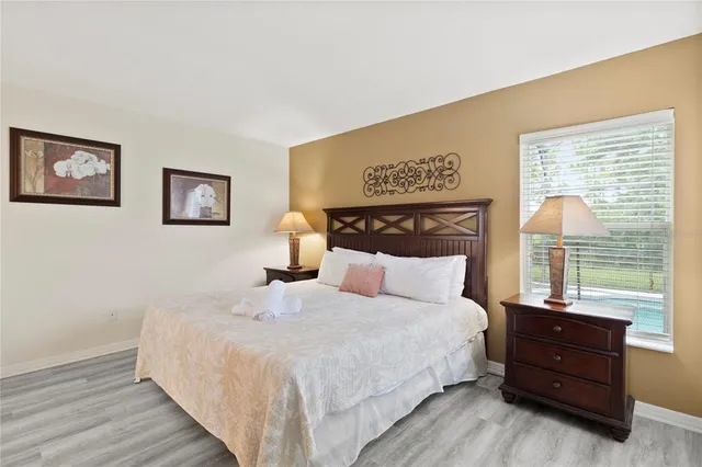 a bedroom with a large bed and a window