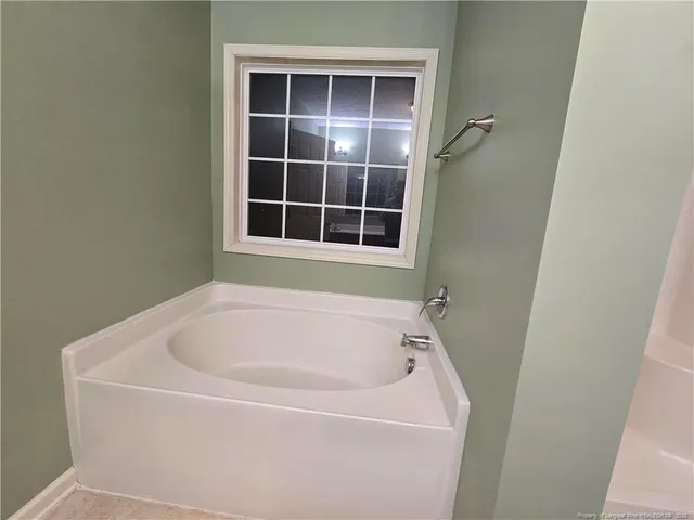 a white bath tub sitting next to a window