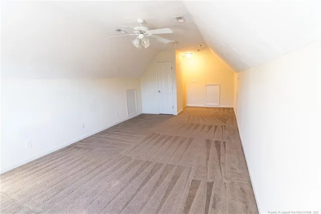 a view of a big room with wooden floor and windows