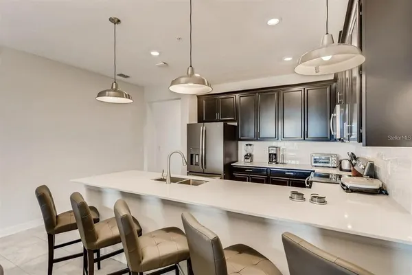 a kitchen with a dining table and chairs