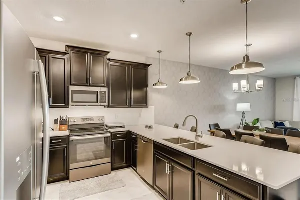 a kitchen with stainless steel appliances a sink stove and refrigerator