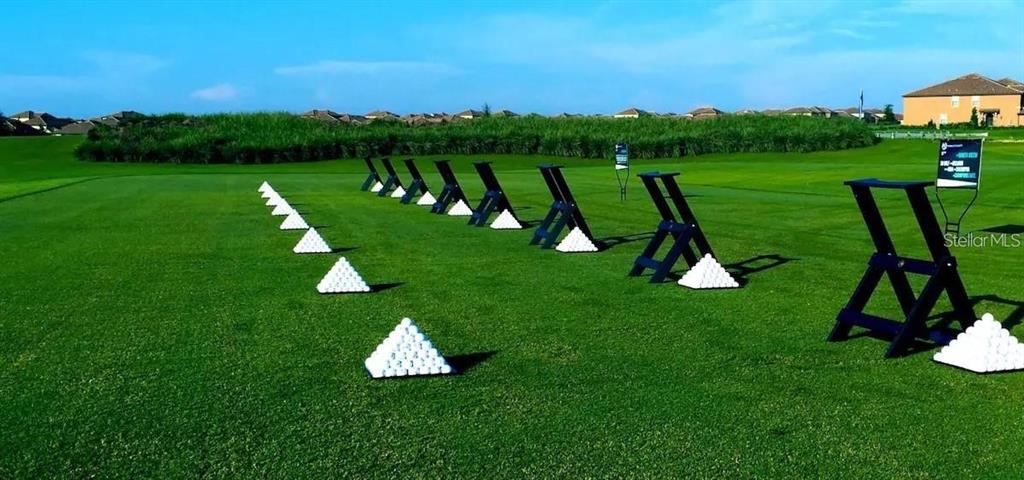 545 Ocean Course Avenue, Unit 545 Davenport, FL 33896 - Photo 30 of 32 a view of a golf course with chairs