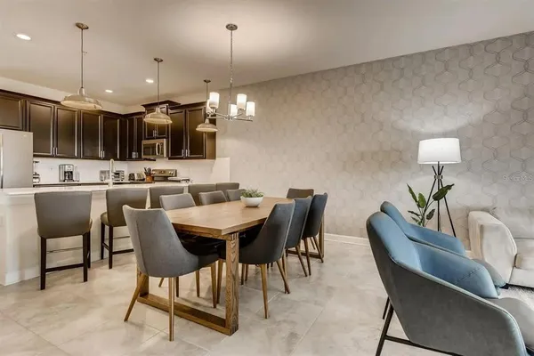 a dining room with furniture and a chandelier