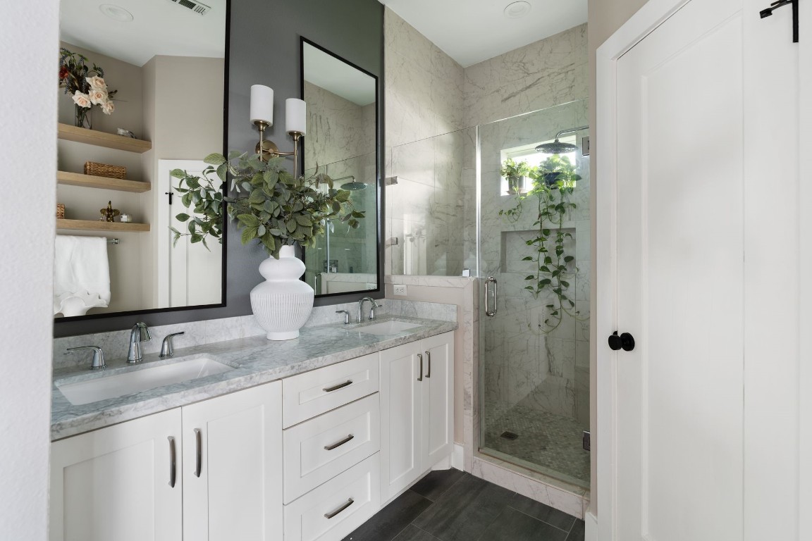 3206 Morrison Street Houston, TX 77009 - Photo 14 of 30 a bathroom with a granite countertop sink a potted plant and a shower
