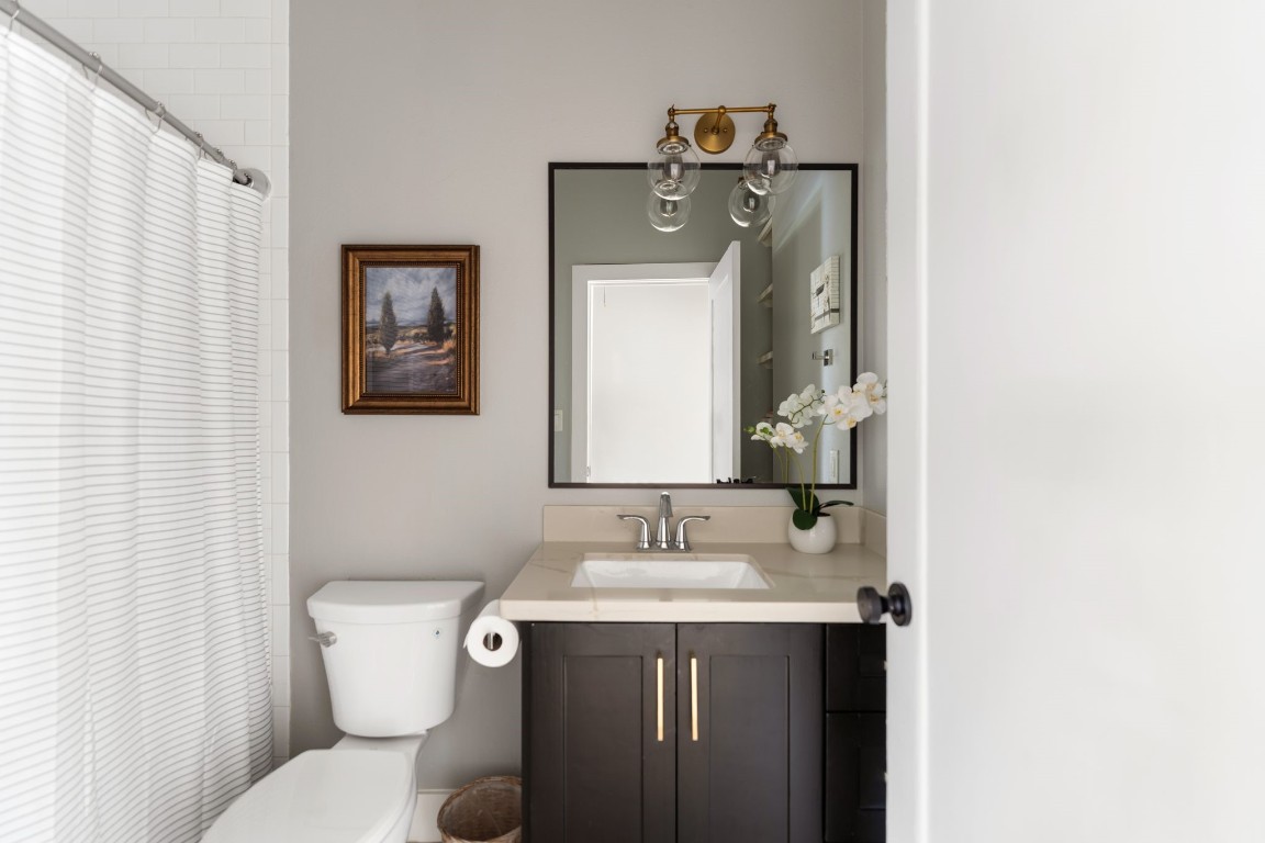 3206 Morrison Street Houston, TX 77009 - Photo 17 of 30 a bathroom with a toilet sink and mirror