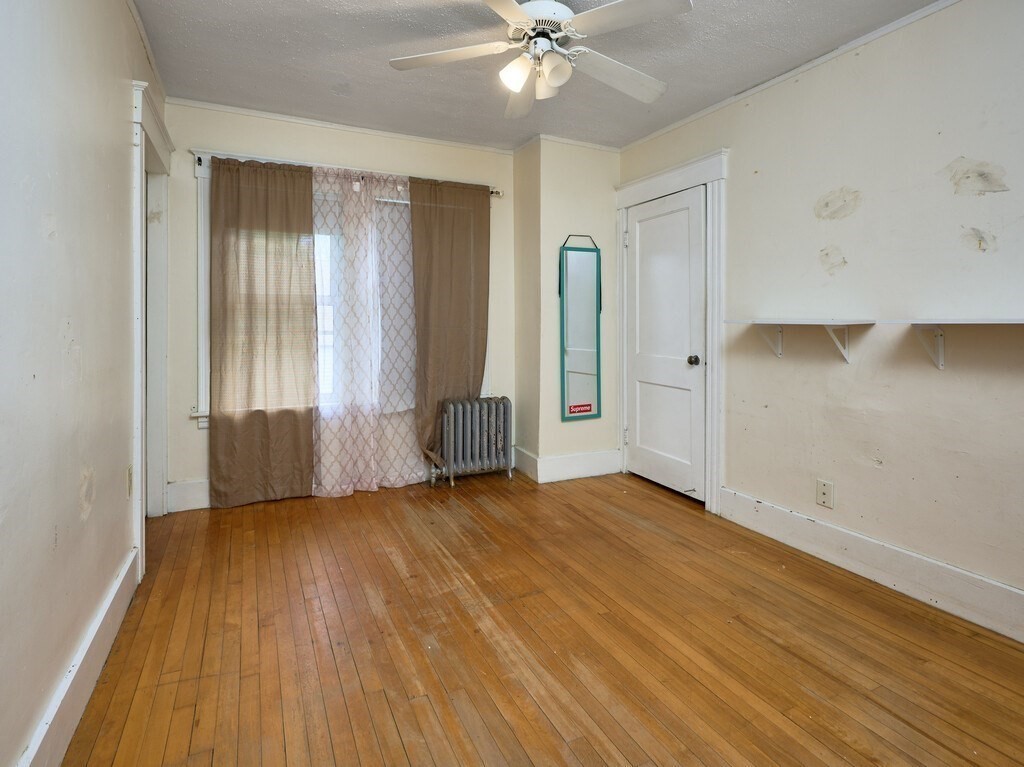 88 Beaconsfield Road Worcester, MA 01602 - Photo 15 of 34 an empty room with wooden floor and windows
