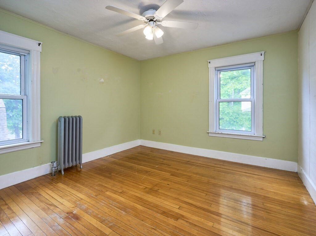 88 Beaconsfield Road Worcester, MA 01602 - Photo 17 of 34 a view of empty room with wooden floor and fan