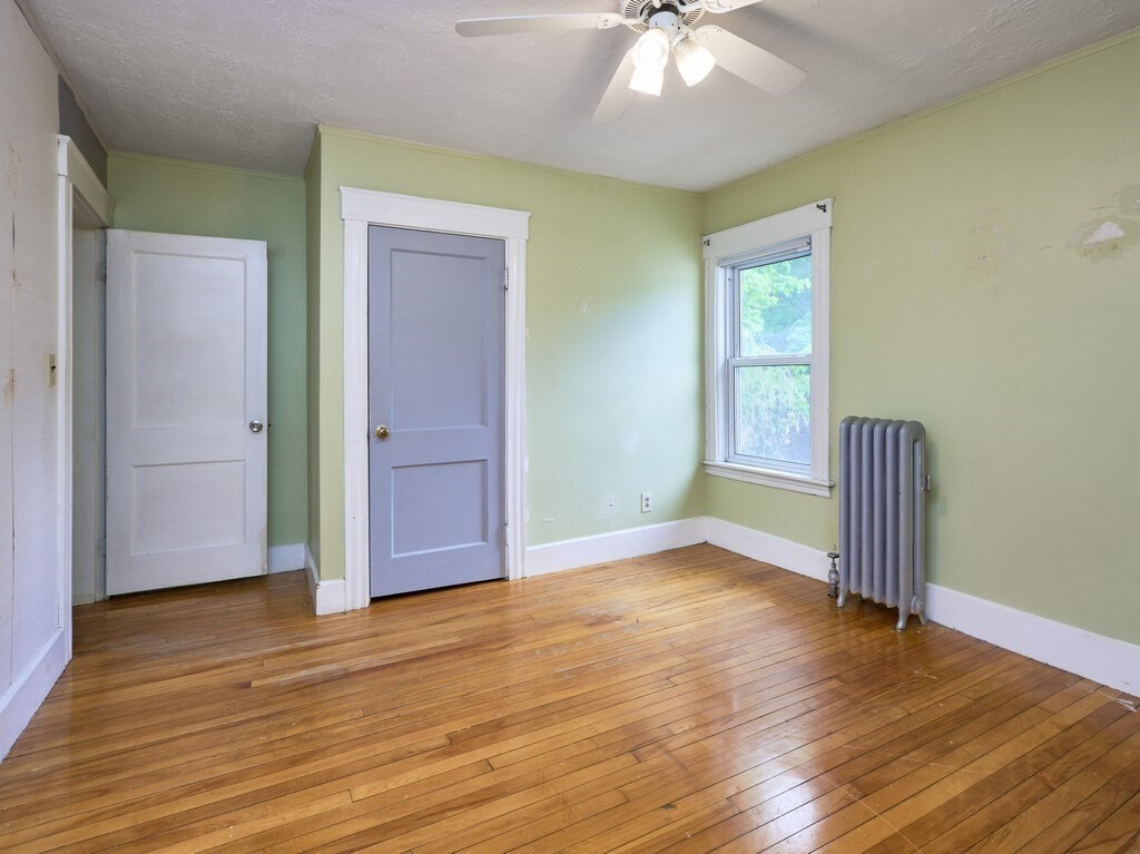 88 Beaconsfield Road Worcester, MA 01602 - Photo 18 of 34 an empty room with wooden floor and door