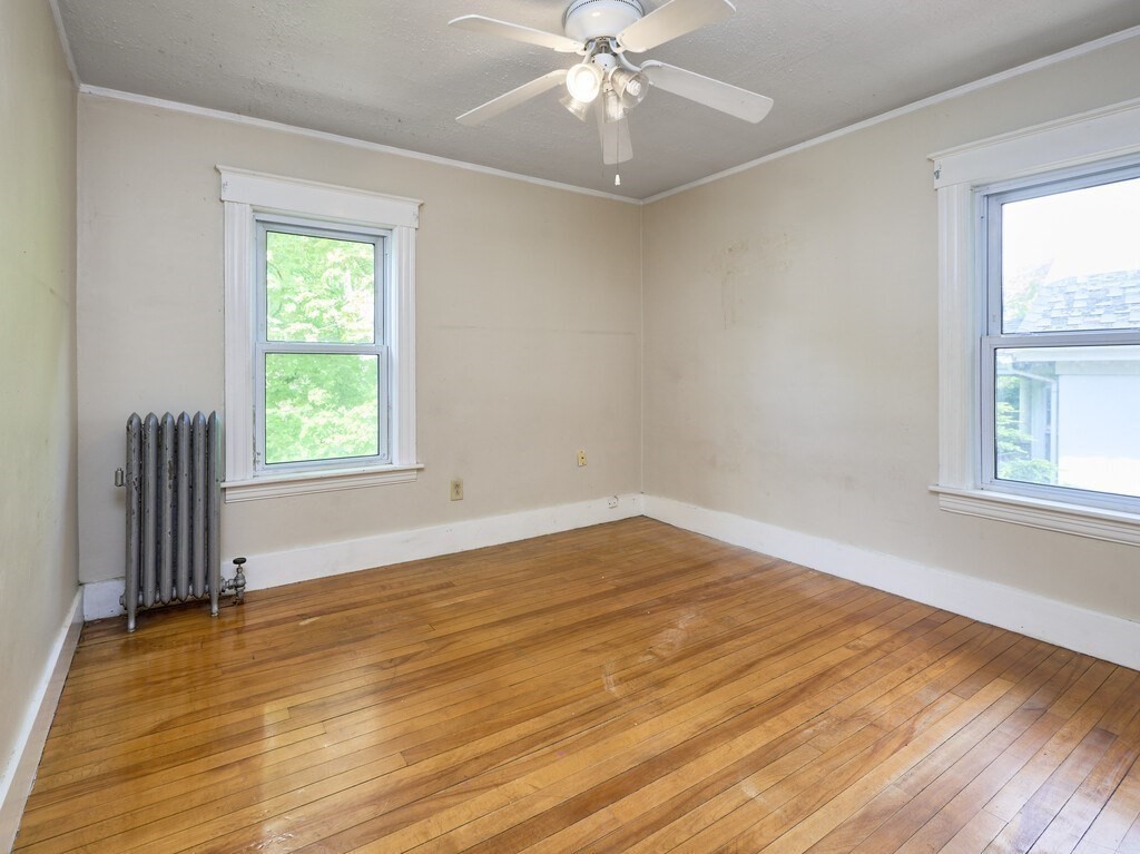 88 Beaconsfield Road Worcester, MA 01602 - Photo 19 of 34 a view of an empty room with wooden floor and a window